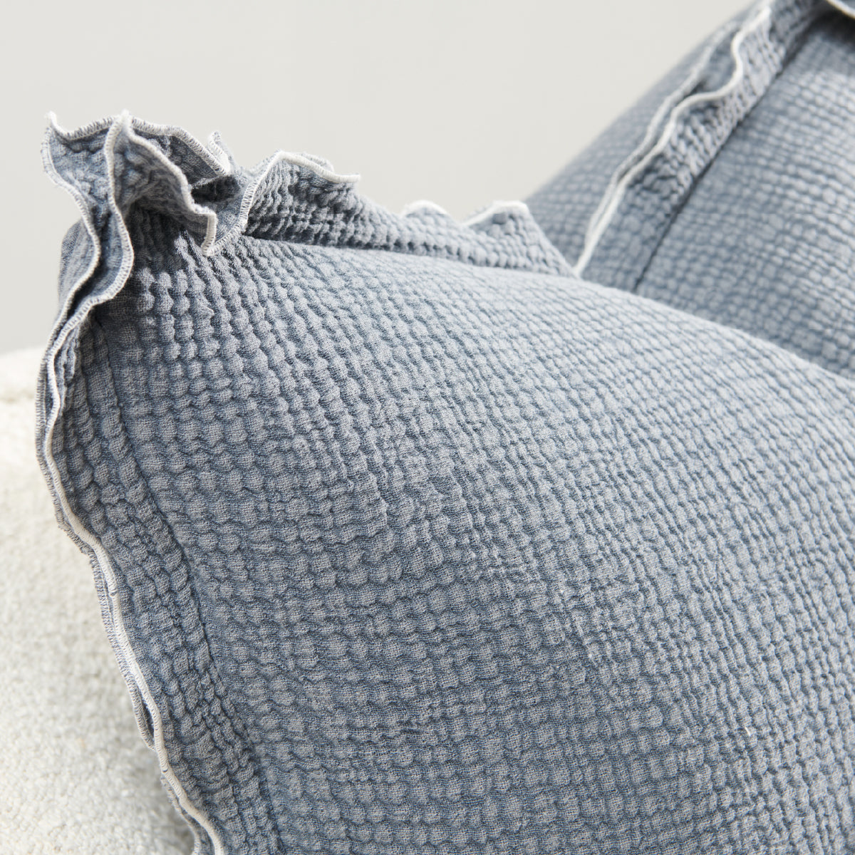 steel blue coloured cushion in a soft fabric with a double flange design and contrast stitching detail