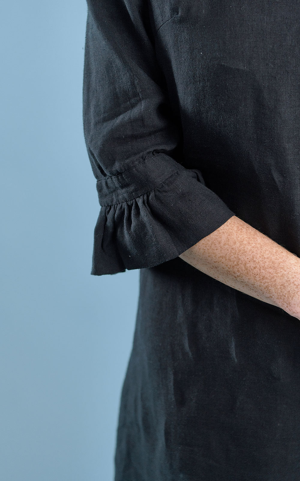 black linen mini dress with high neck frill and sleeves