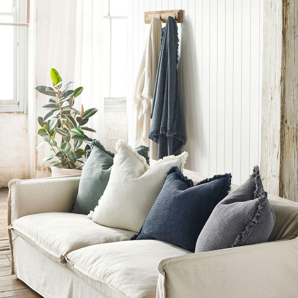 Chelsea cushions in white, khaki, navy and slate on a sofa