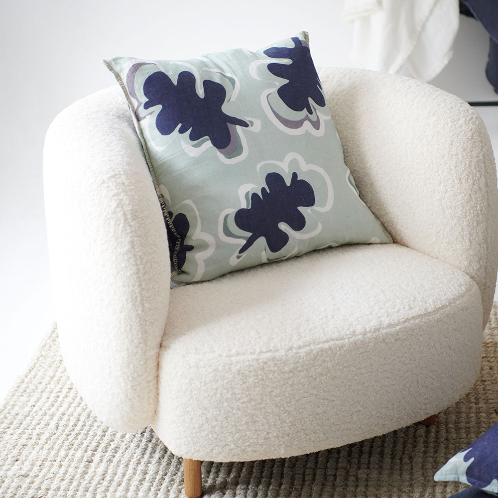 100% linen cushion in a sea mist and navy leaf abstract pattern and a contrast stitch feature