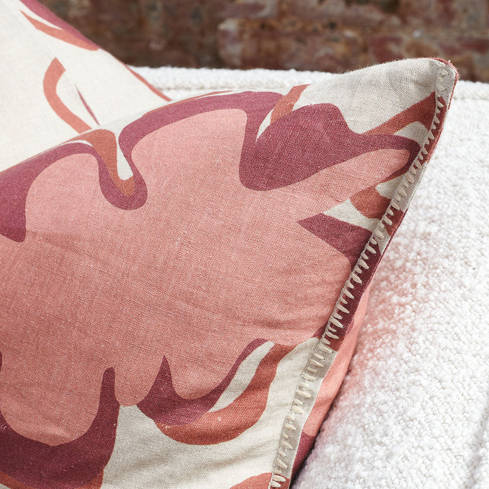 pink, maroon and natural fun patterned linen cushion with contrast stitching feature