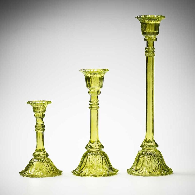 glass candlestick holders in multiple sizes in green