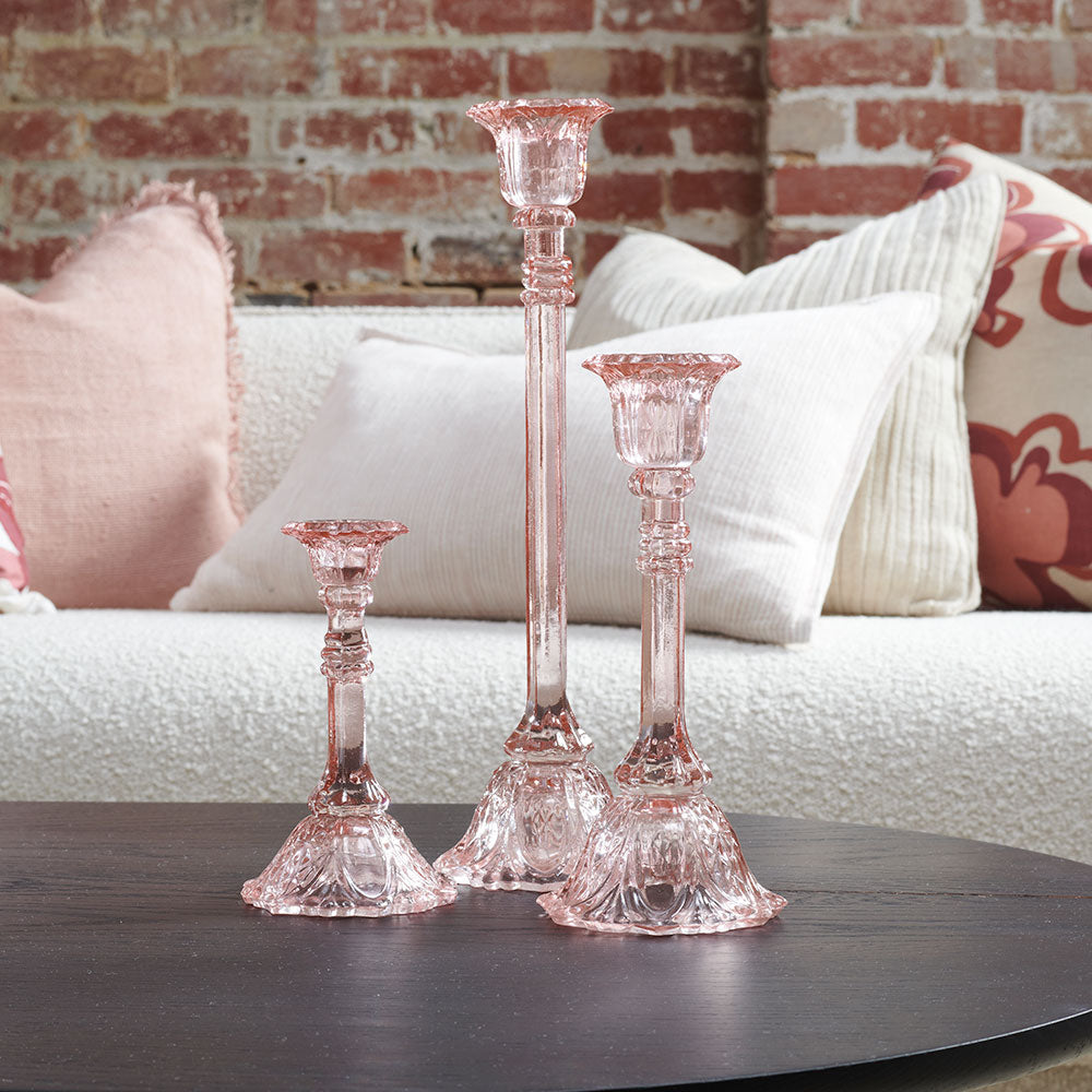 glass candlestick holders in multiple sizes in pink