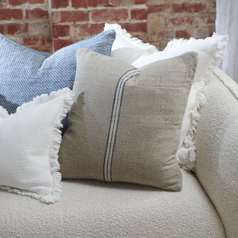 hand woven cushion in natural with a simple stripe feature in the middle