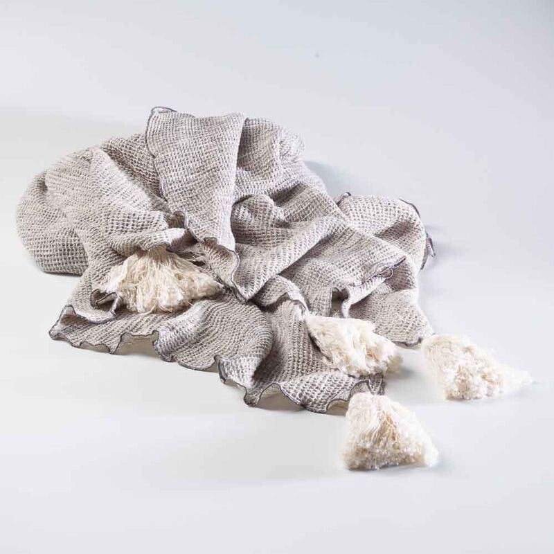 silver grey textured linen throw with cream tassels and lettuce trim edges