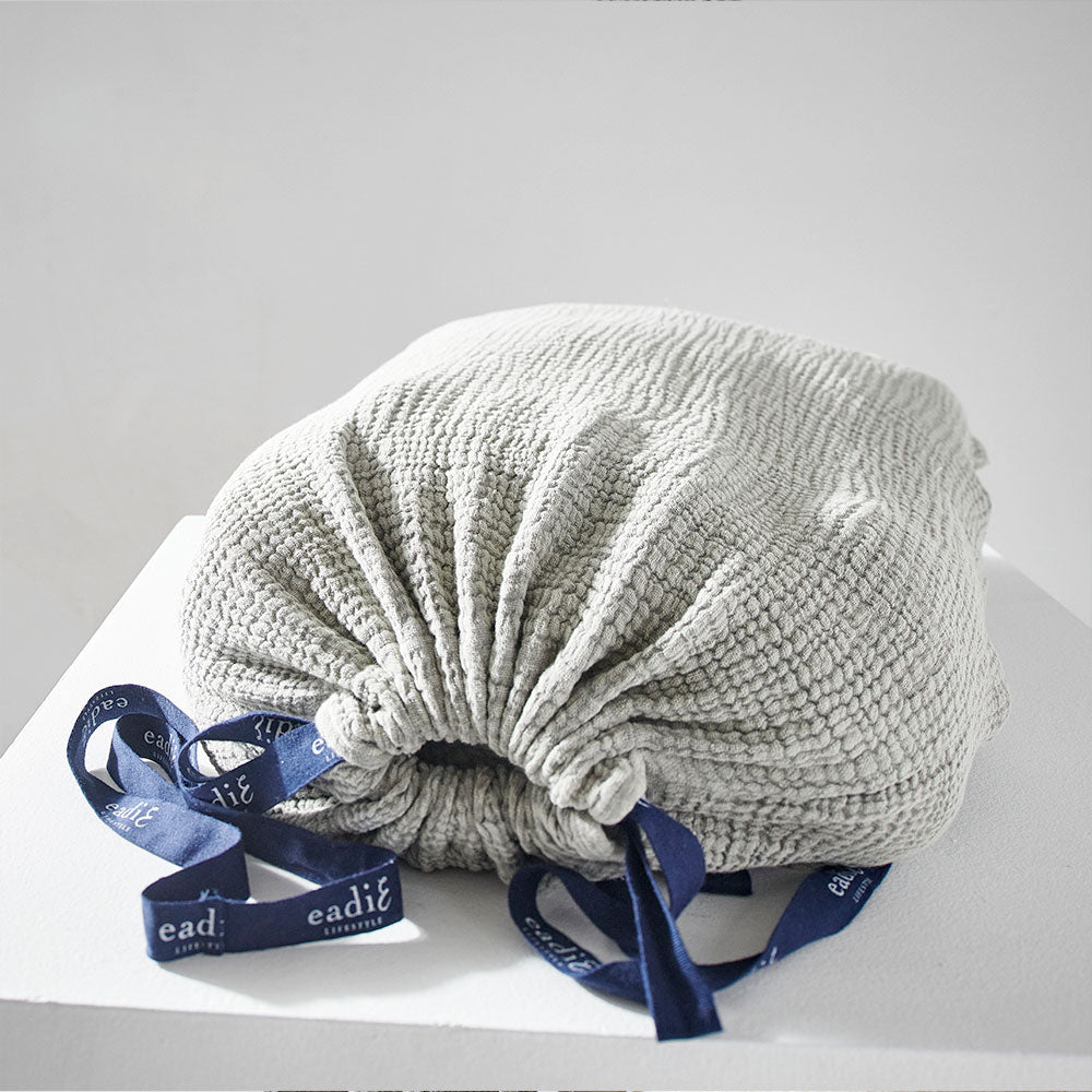 pistachio coloured duvet set with contrast stitching, lettuce edge and wooden button feature