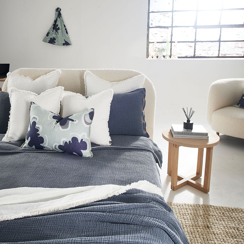 steel blue duvet set with contrast stitching, lettuce edge and wooden button feature