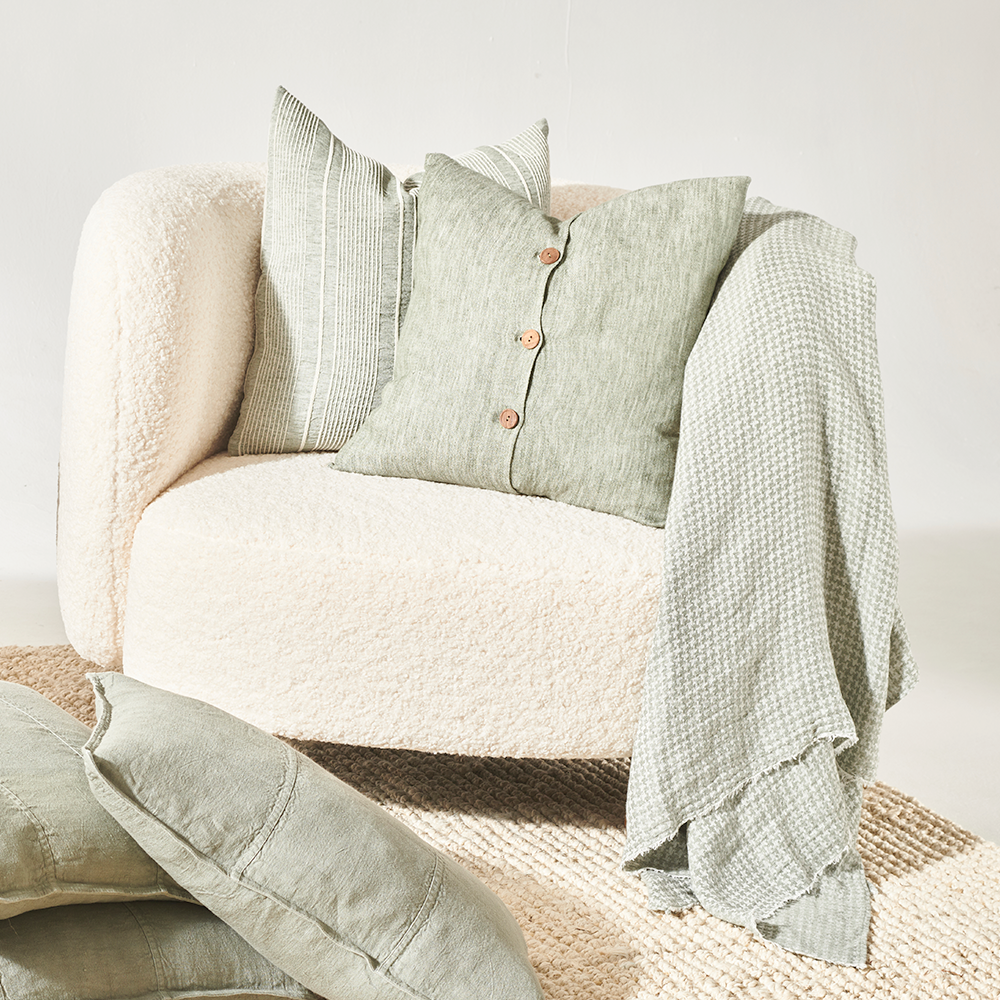 pistachio linen cushion with wooden button feature
