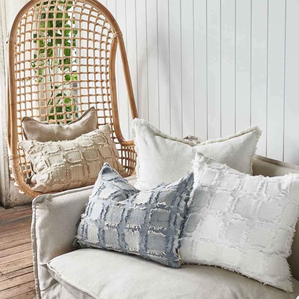 bedu cushions and luca linen and luca boho cushions sitting on a hanging chair and sofa