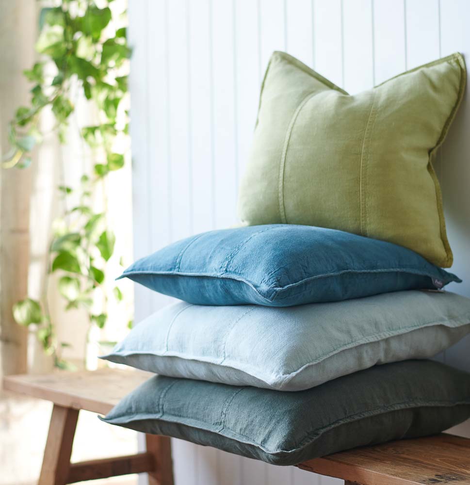 Luca Linen cushions stacked on a bench seat