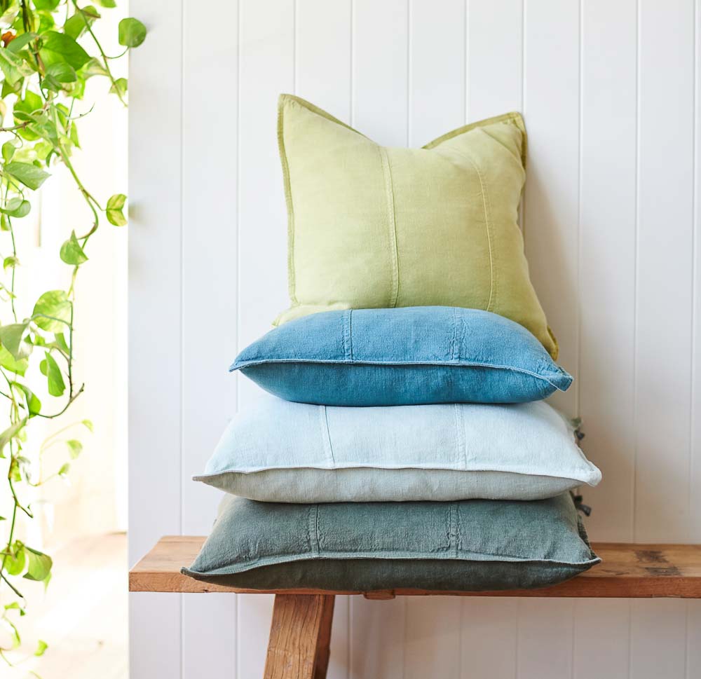Luca Linen cushions stacked on a bench seat