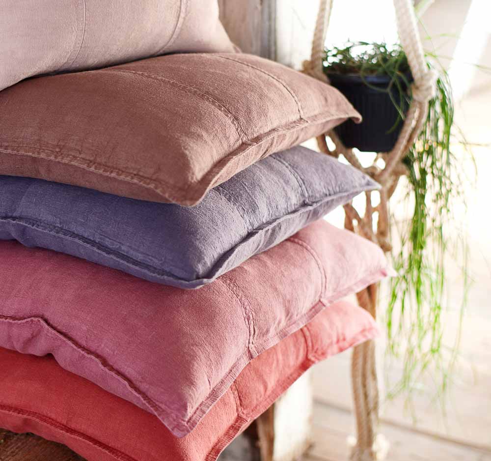 Luca Linen cushions stacked on a bench seat