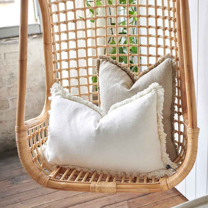 Luca Boho Linen Cushions on a cane hanging chair