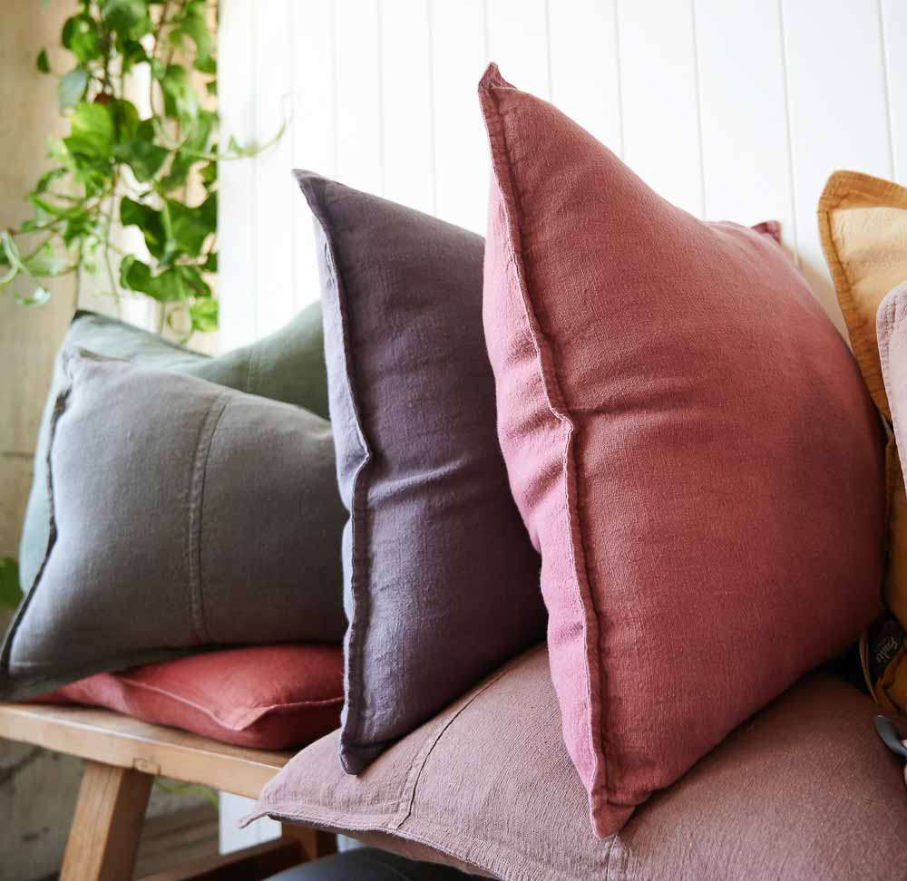 Luca Linen cushions stacked on a bench seat