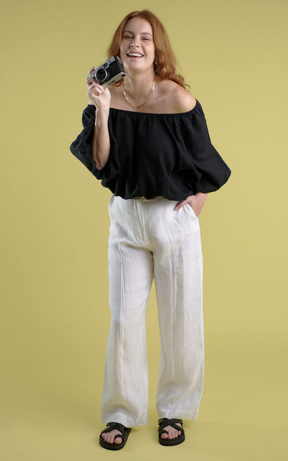 tailored linen pants with wooden button and single pleat down the front in white