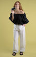 tailored linen pants with wooden button and single pleat down the front in white