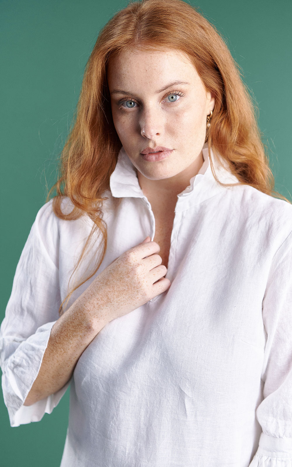 white linen mini dress with high neck frill and sleeves