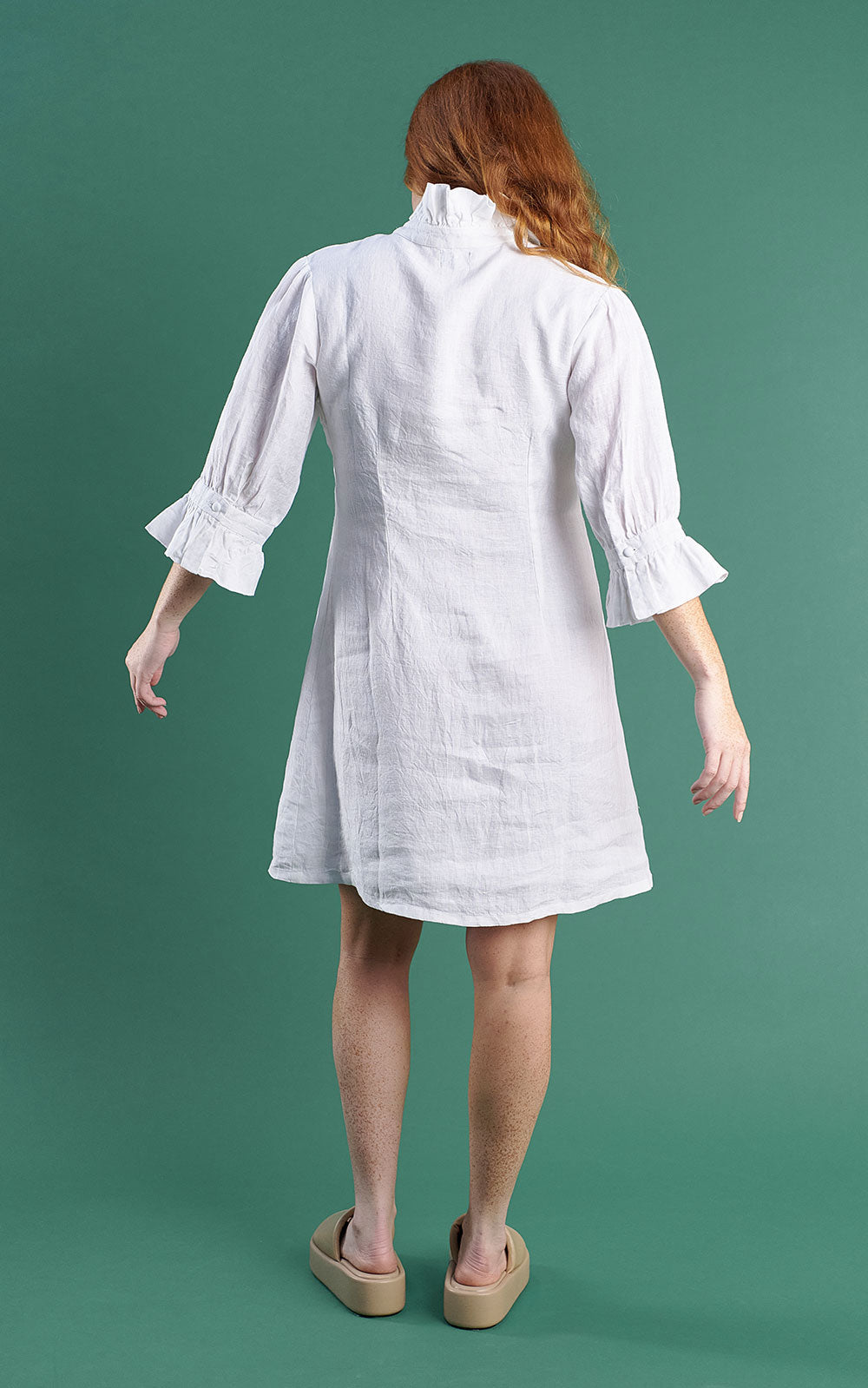 white linen mini dress with high neck frill and sleeves