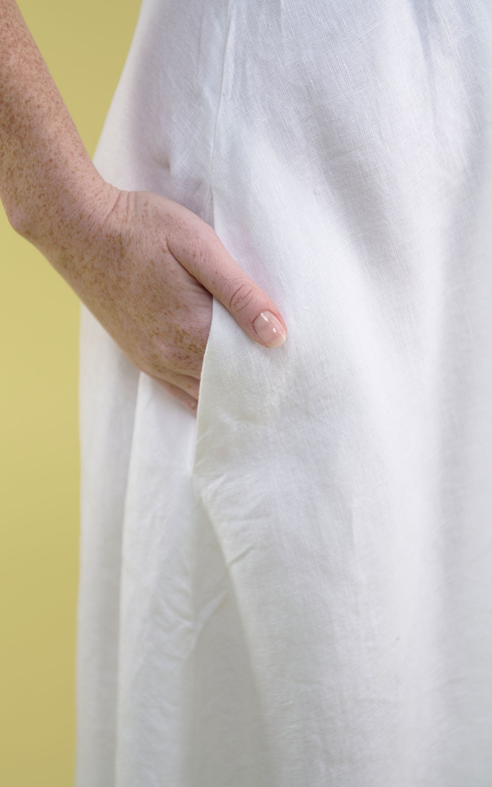 white linen maxi dress with v neck and middle leg split including tie belt