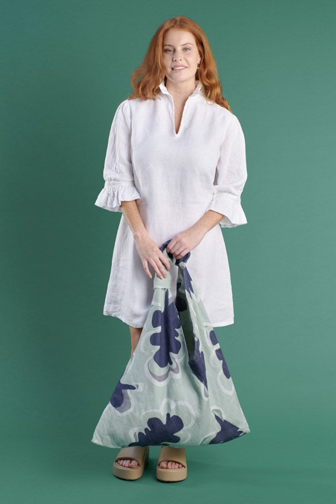 white linen mini dress with high neck frill and sleeves