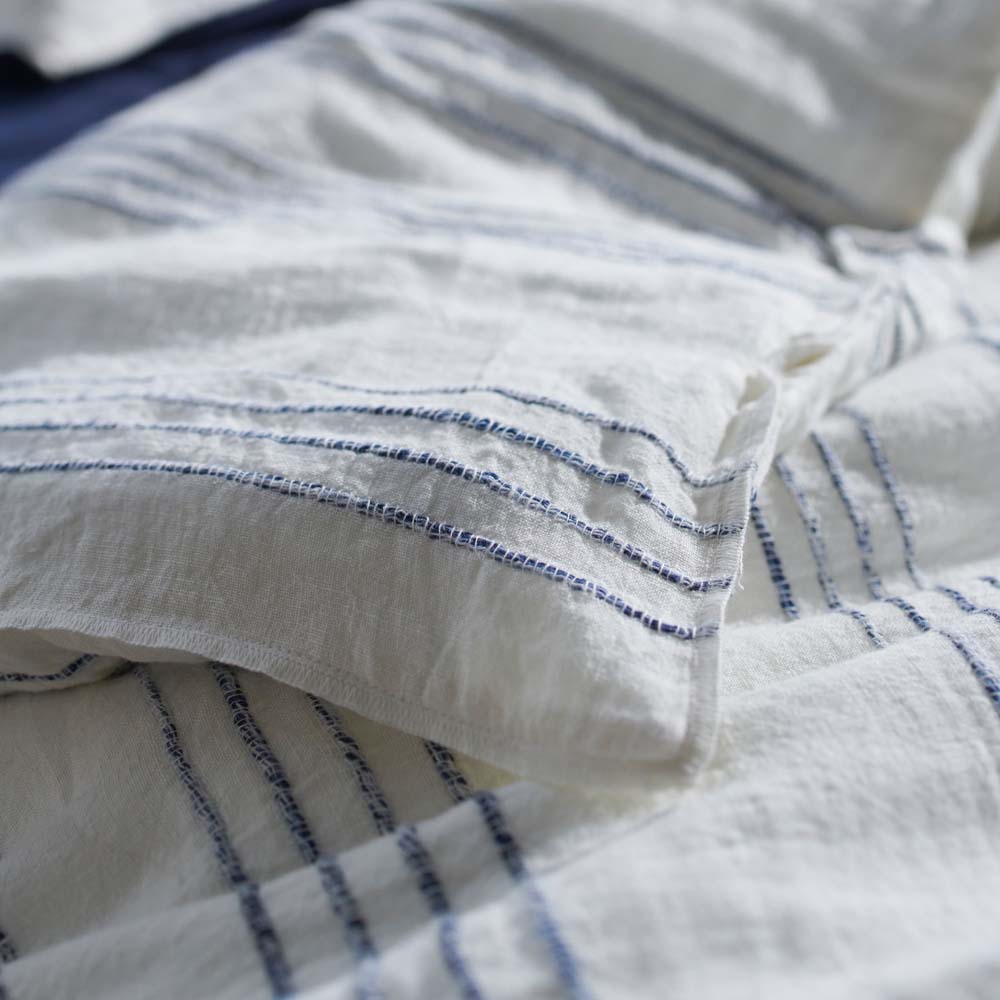rockpool linen quilt cover and linen pillow cases in white with navy stripe