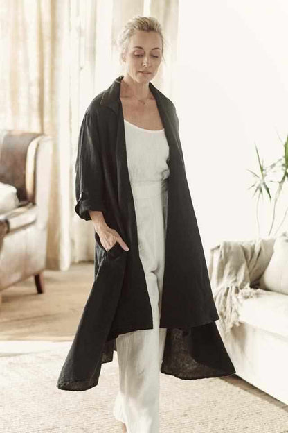 Euro linen white cami and euro linen white wide leg pant layered with the black cascade coat