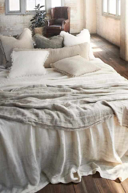 Natural Bedouin Oversized Linen Bed Throw layered with Bedouin Linen Cushions  on bed