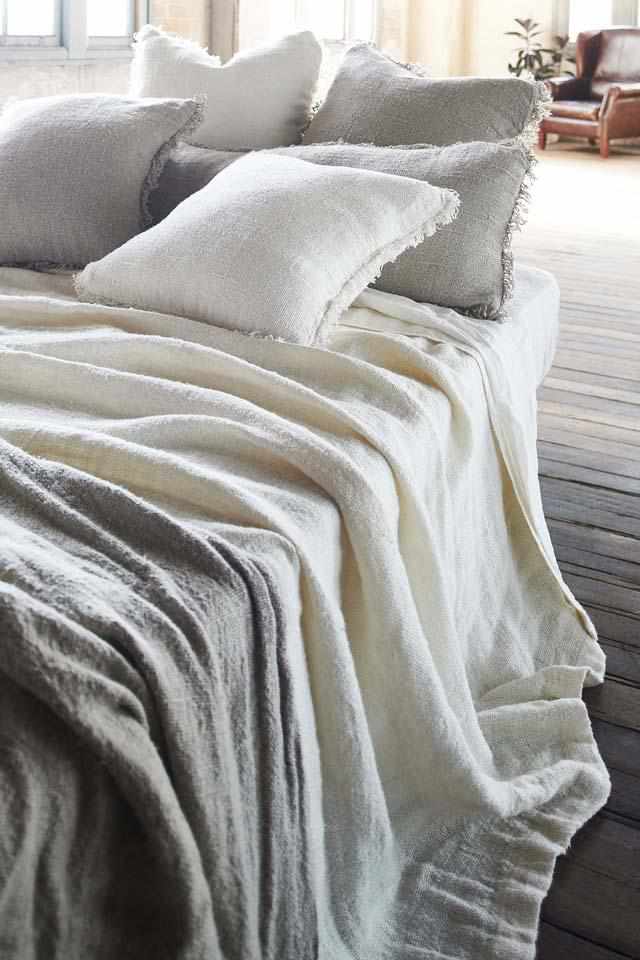 White Bedouin Oversized Linen Bed Throw layered with Bedouin Linen Cushions  on bed