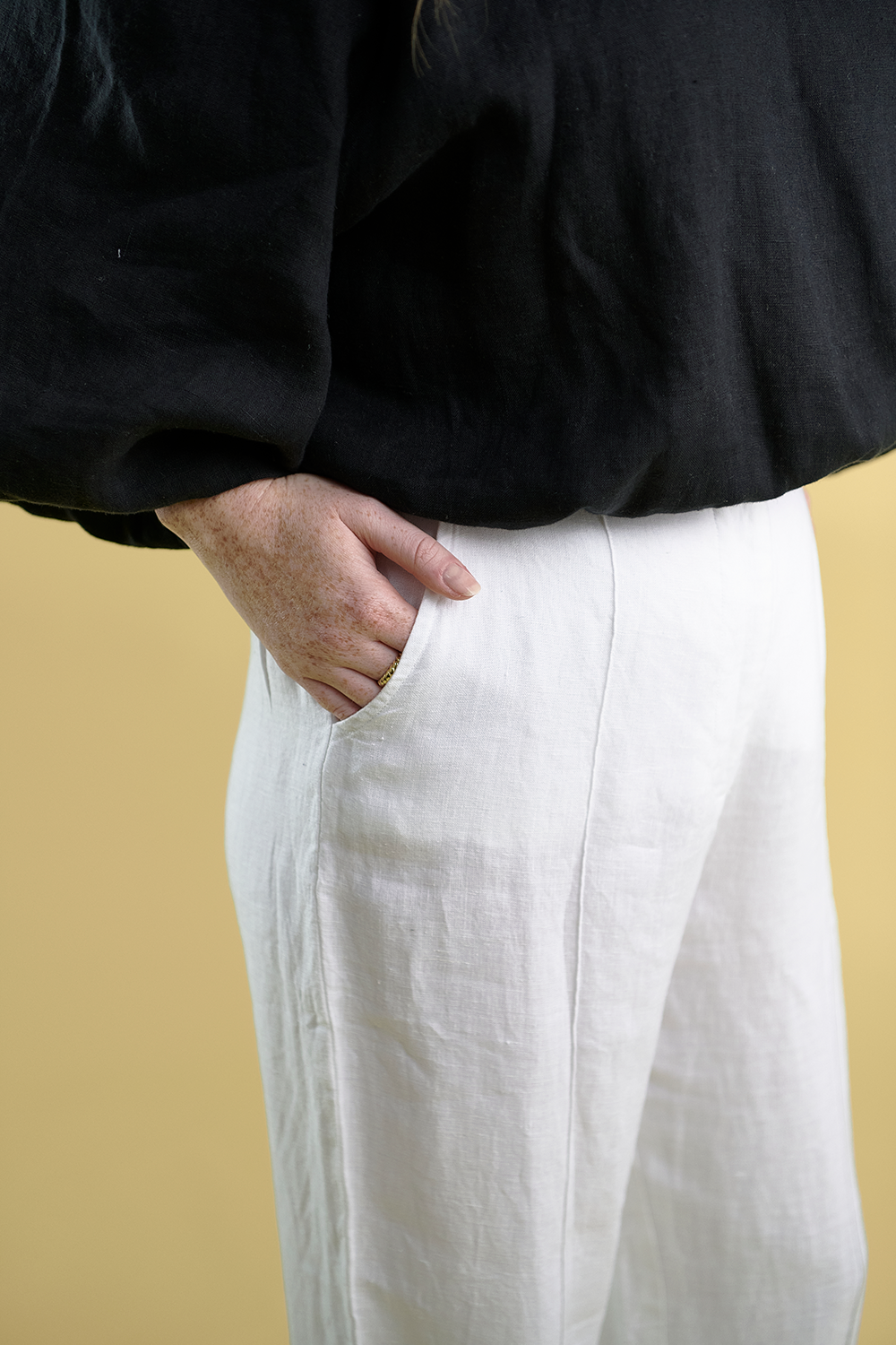 tailored linen pants with wooden button and single pleat down the front in white