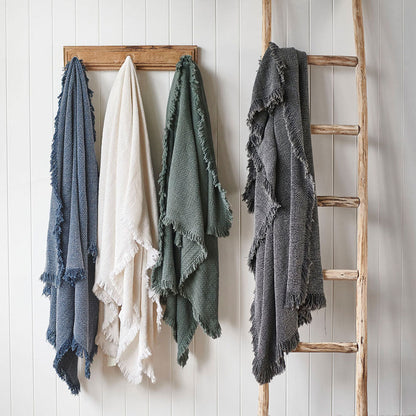 Chelsea throws in Navy, White, Khaki and Slate hanging on a rack