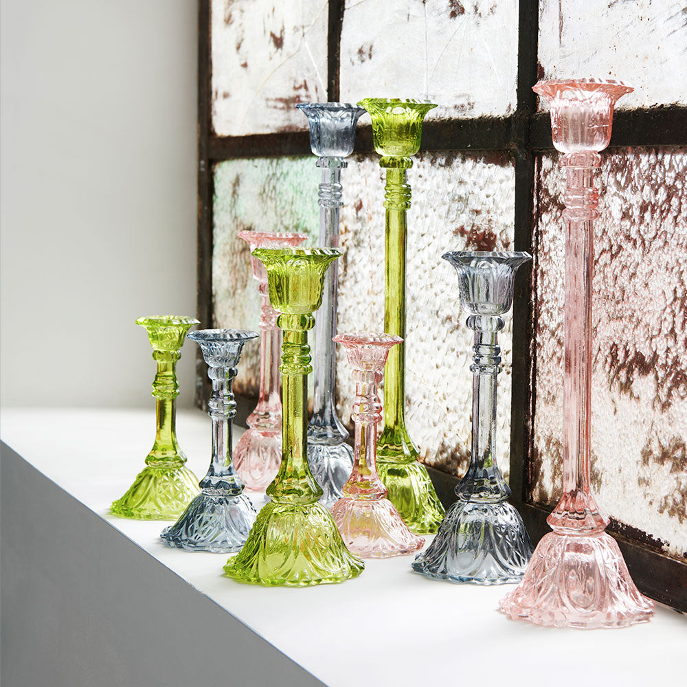 glass candlestick holders in multiple sizes in green