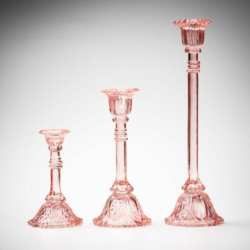 glass candlestick holders in multiple sizes in pink