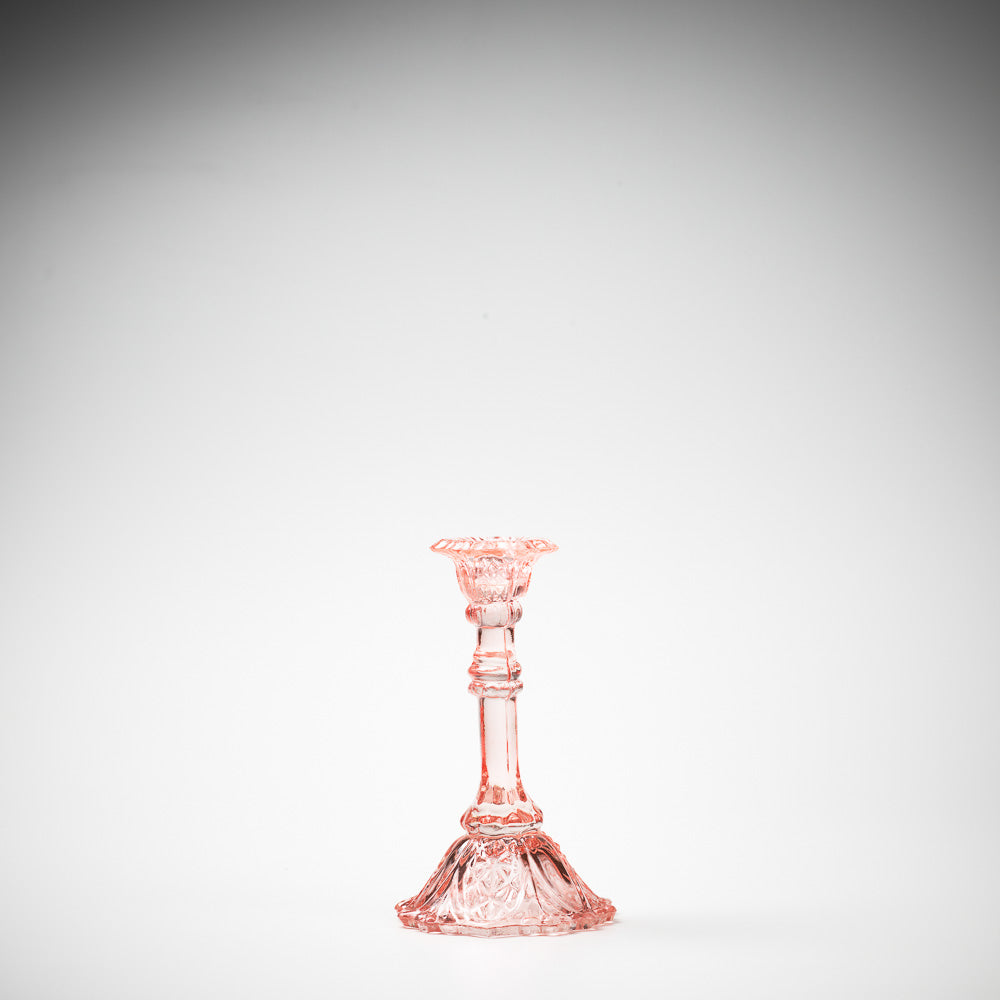glass candlestick holders in multiple sizes in pink