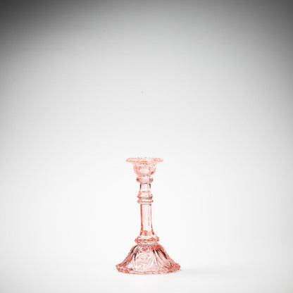 glass candlestick holders in multiple sizes in pink