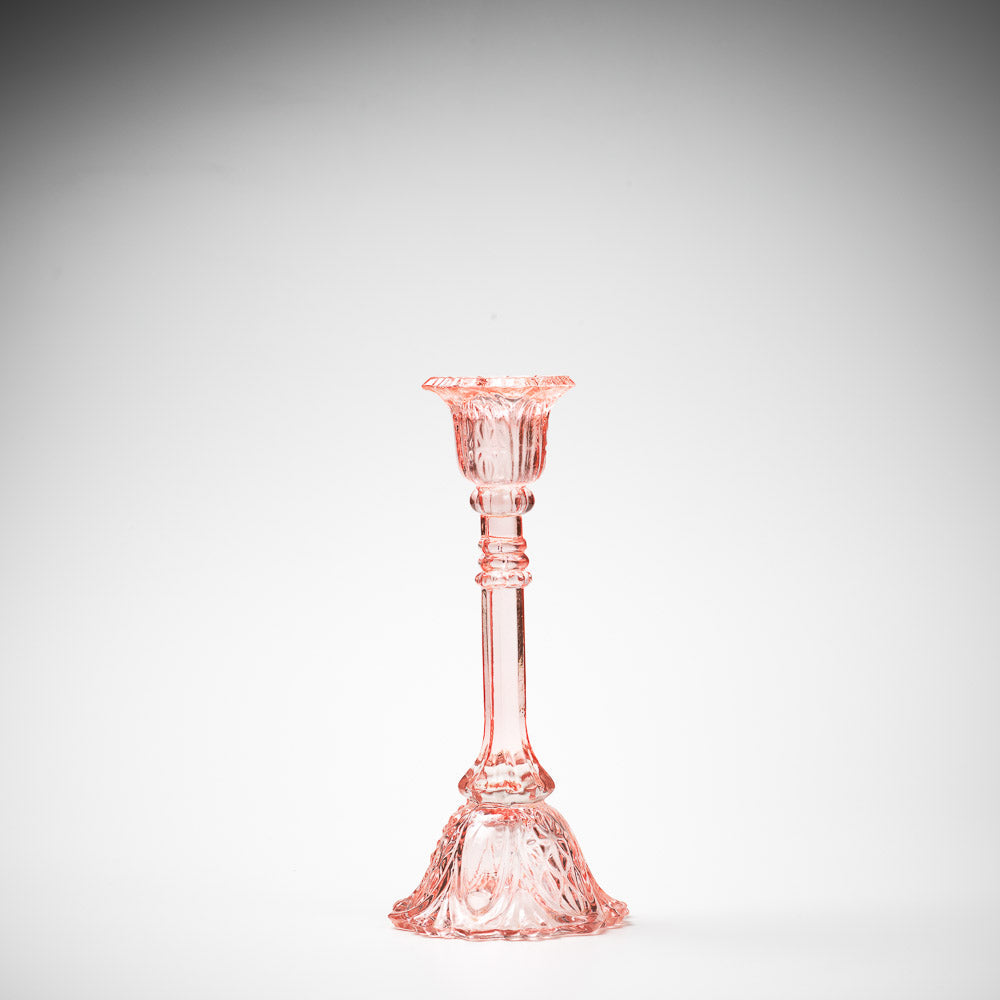 glass candlestick holders in multiple sizes in pink
