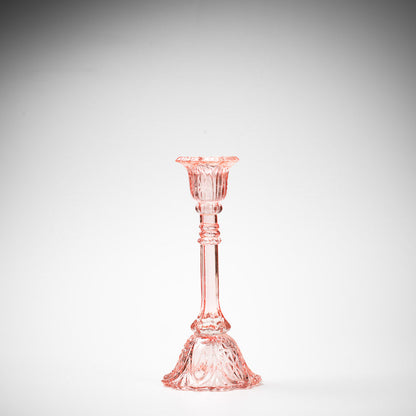 glass candlestick holders in multiple sizes in pink