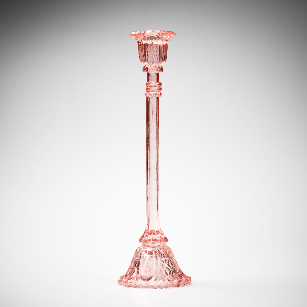 glass candlestick holders in multiple sizes in pink