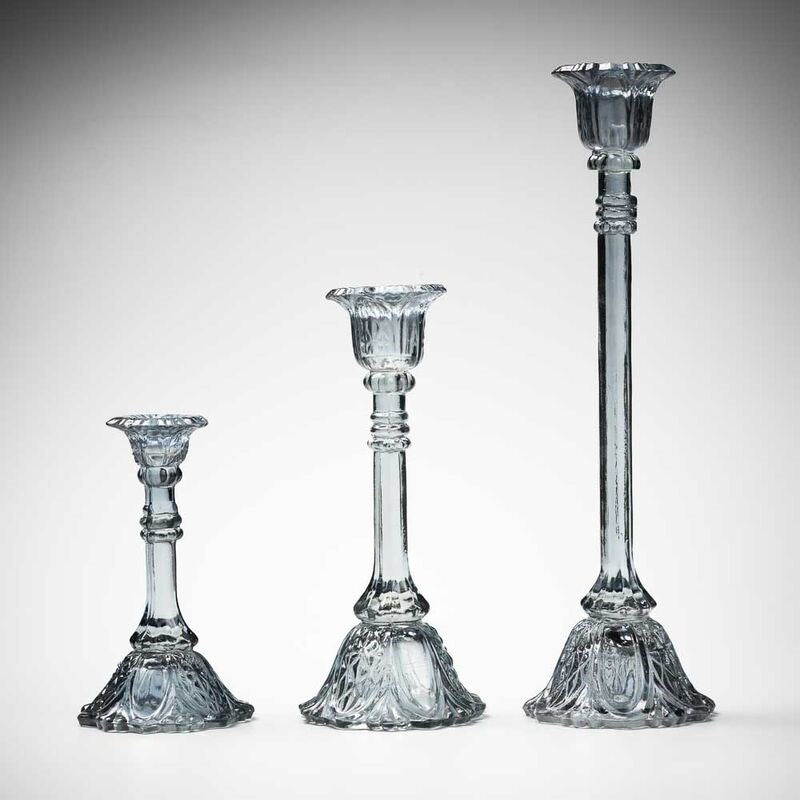 glass candlestick holders in multiple sizes in grey
