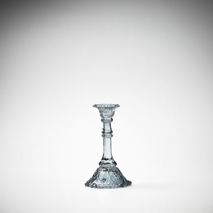 glass candlestick holders in multiple sizes in grey