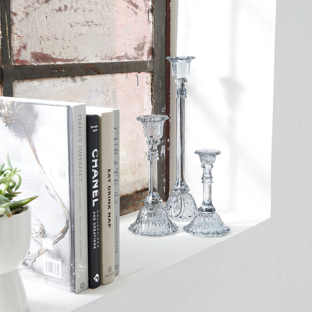 glass candlestick holders in multiple sizes in grey