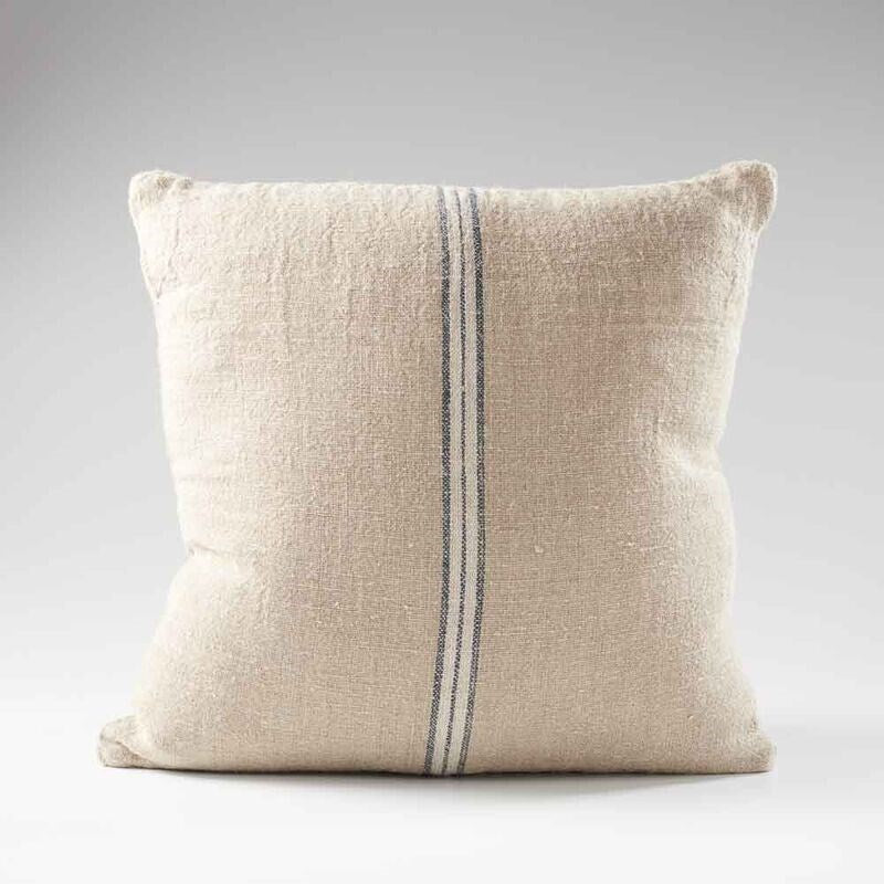 hand woven cushion in natural with a simple stripe feature in the middle
