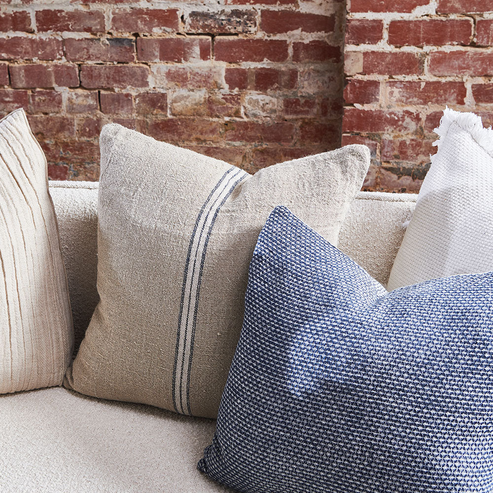 hand woven cushion in natural with a simple stripe feature in the middle