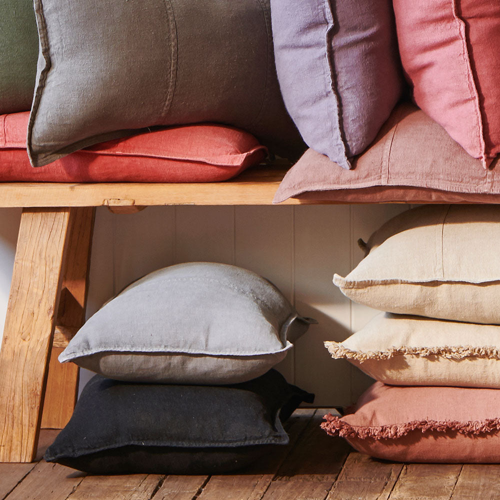 Luca Linen cushions stacked on a bench seat