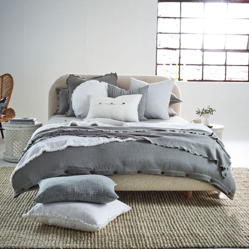 pistachio coloured duvet set with contrast stitching, lettuce edge and wooden button feature