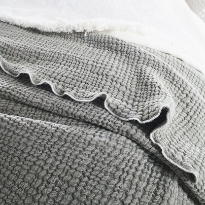 pistachio coloured duvet set with contrast stitching, lettuce edge and wooden button feature