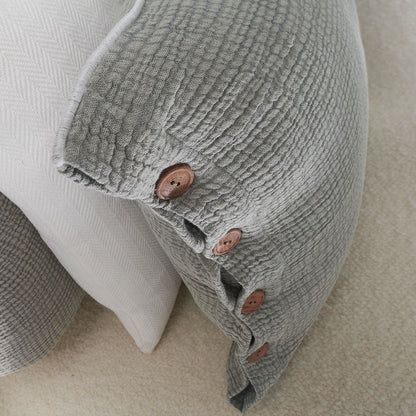 pistachio coloured duvet set with contrast stitching, lettuce edge and wooden button feature