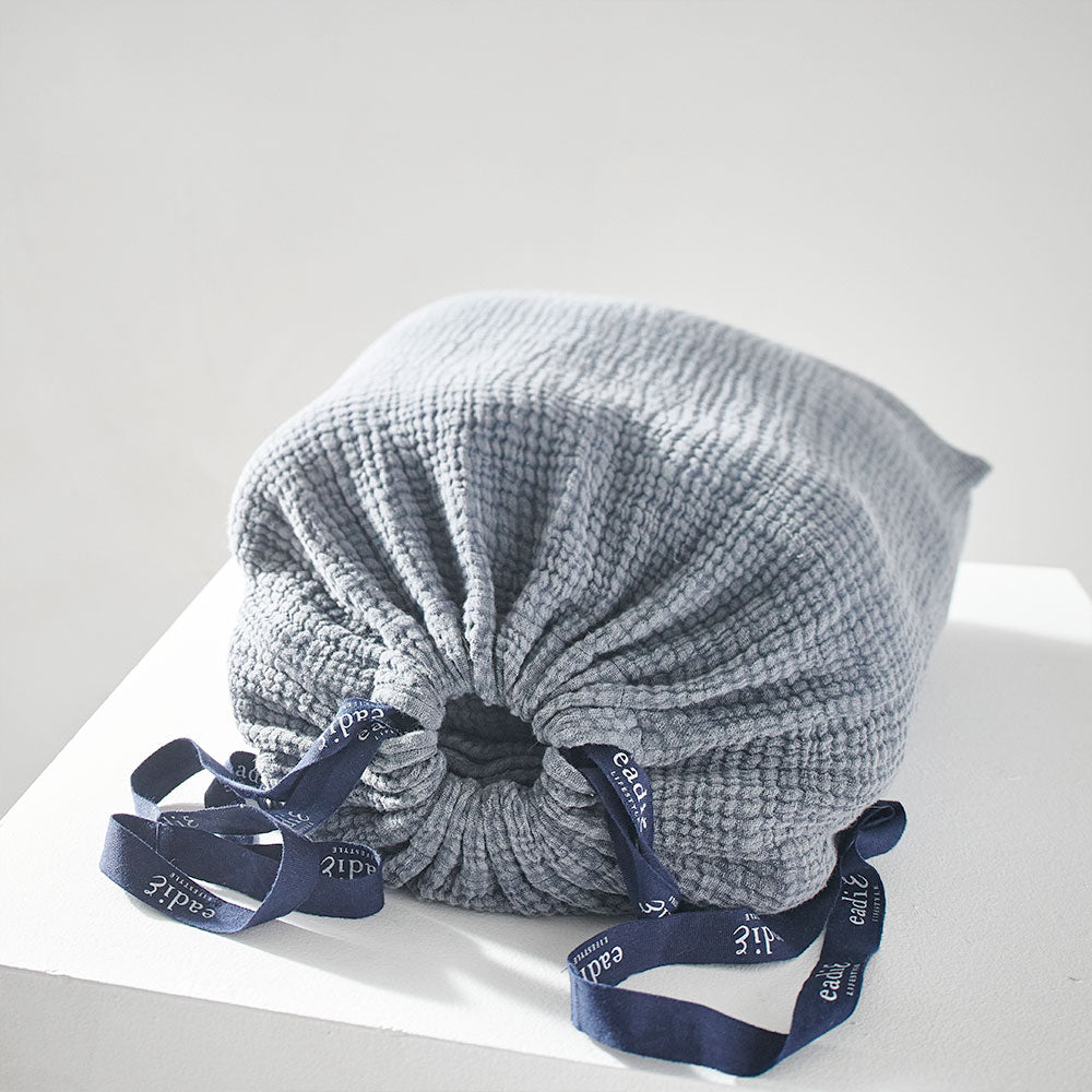 steel blue duvet set with contrast stitching, lettuce edge and wooden button feature