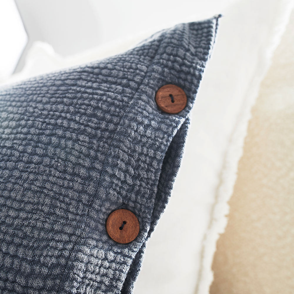 steel blue duvet set with contrast stitching, lettuce edge and wooden button feature