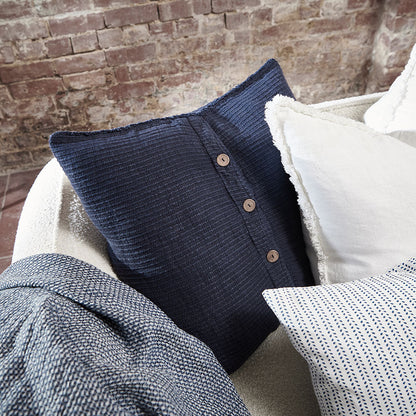 navy blue ribbed linen cushion with wooden button closure feature and frayed edging
