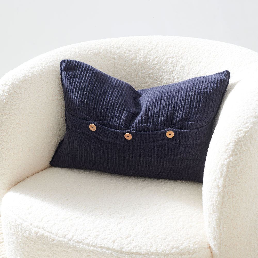 navy blue ribbed linen cushion with wooden button closure feature and frayed edging